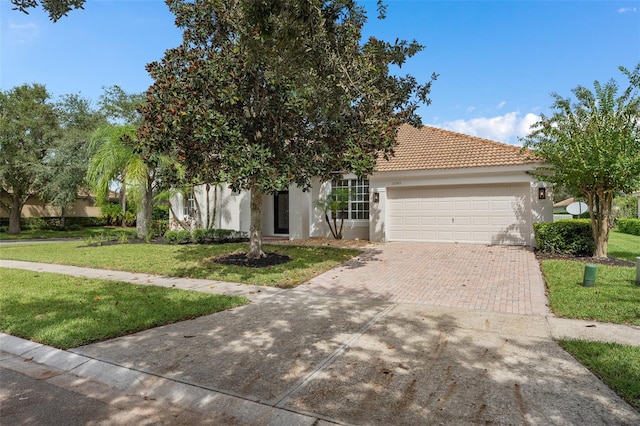 view of front facade featuring a front lawn and a garage