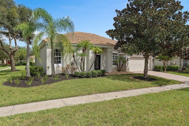 view of front of property with a front lawn and a garage