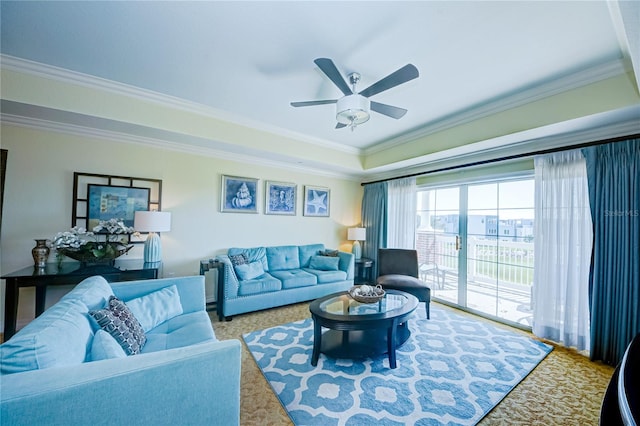 living room with ornamental molding, carpet flooring, and ceiling fan