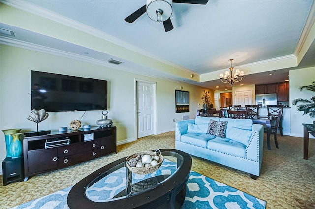 carpeted living room with crown molding, a raised ceiling, and ceiling fan with notable chandelier