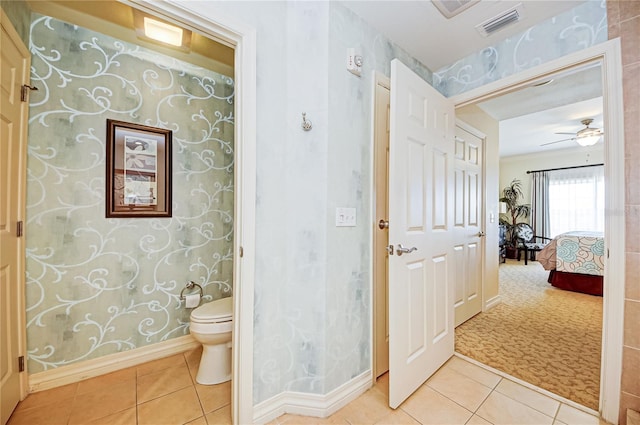 bathroom with toilet, tile patterned flooring, and ceiling fan