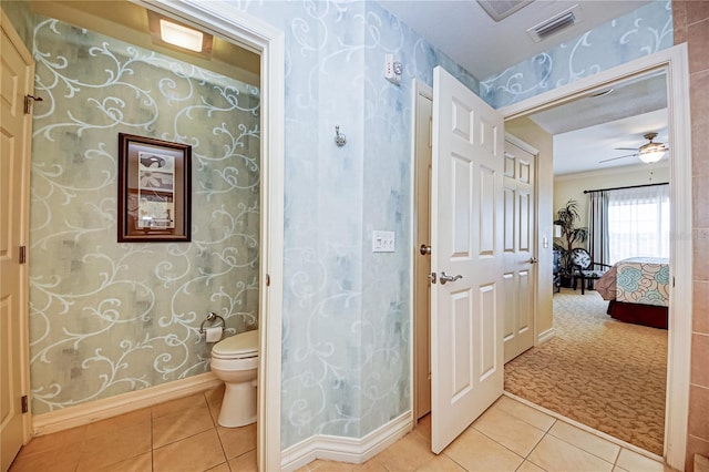 bathroom with toilet, tile patterned floors, and ceiling fan