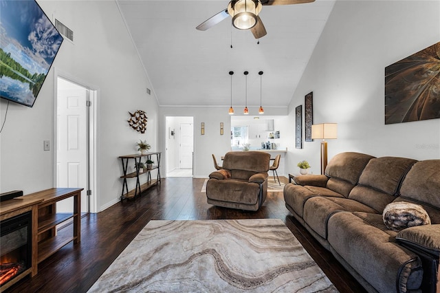 living room featuring ceiling fan, dark wood-type flooring, and high vaulted ceiling