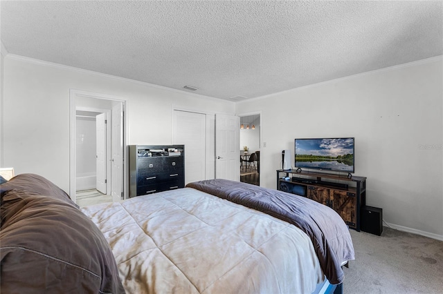 carpeted bedroom featuring ensuite bathroom, a textured ceiling, and ornamental molding