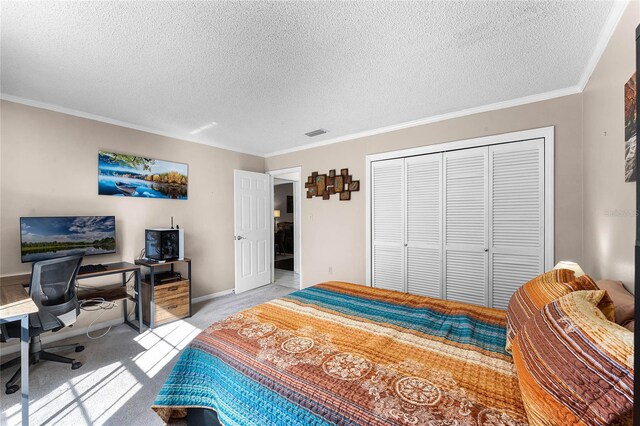 carpeted bedroom featuring ornamental molding, a textured ceiling, and a closet