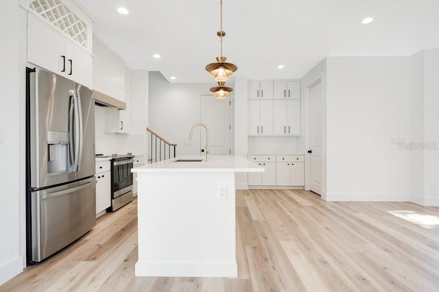 kitchen featuring pendant lighting, white cabinets, sink, light hardwood / wood-style flooring, and stainless steel appliances