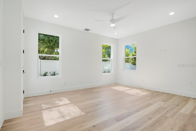 spare room featuring light hardwood / wood-style flooring and ceiling fan