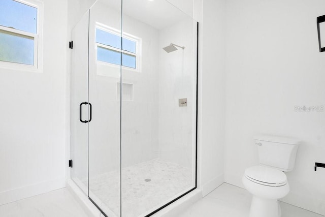 bathroom with an enclosed shower and toilet