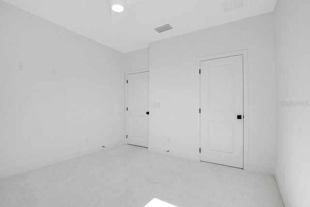 unfurnished bedroom featuring light colored carpet