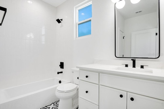 full bathroom with vanity, toilet, and tiled shower / bath combo