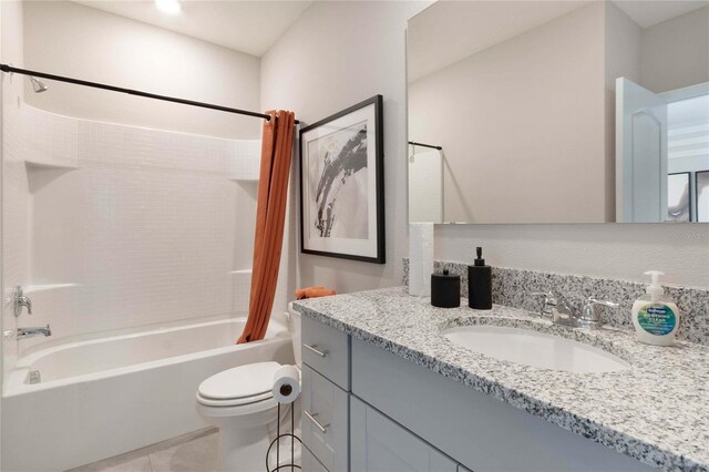 full bathroom featuring toilet, tile patterned flooring, shower / bath combination with curtain, and vanity