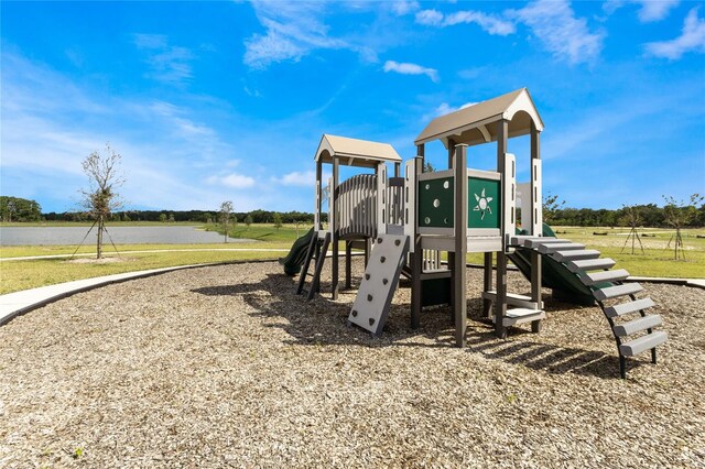 view of playground featuring a water view and a yard