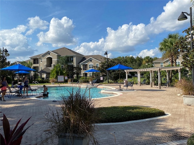 view of swimming pool with a pergola and a patio area