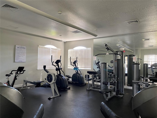 workout area with a textured ceiling