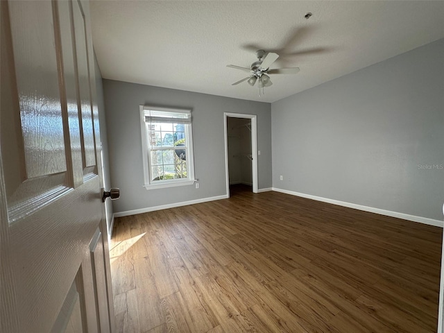 spare room featuring ceiling fan, wood-type flooring, and a textured ceiling