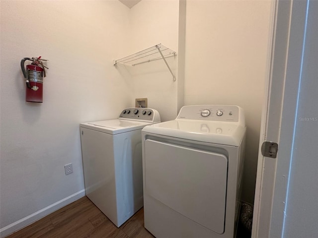 washroom featuring washing machine and dryer and hardwood / wood-style flooring