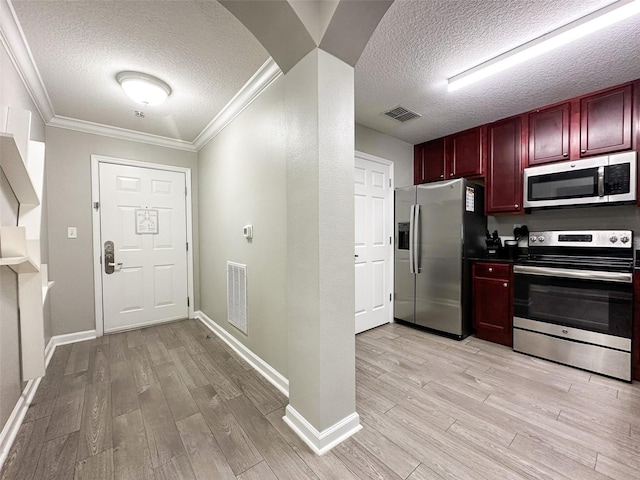14501 Grove Resort Ave Unit 1507, Winter Garden, FL 34787 - kitchen featuring appliances with stainless steel finishes, dark brown cabinets, a textured ceiling, light wood finished floors, and crown molding