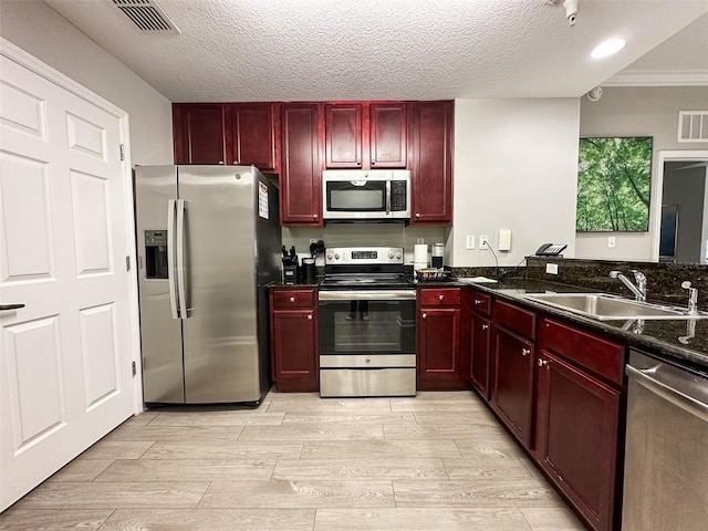 14501 Grove Resort Ave Unit 1507, Winter Garden, FL 34787 - kitchen featuring stainless steel appliances, reddish brown cabinets, wood finish floors, crown molding, and a textured ceiling