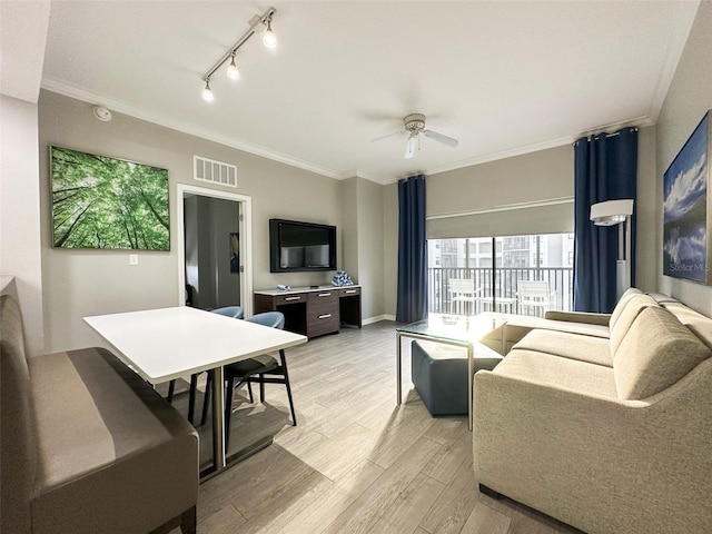 living room with crown molding, light wood-type flooring, and ceiling fan