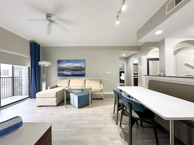 living room with crown molding, track lighting, light wood-type flooring, and ceiling fan