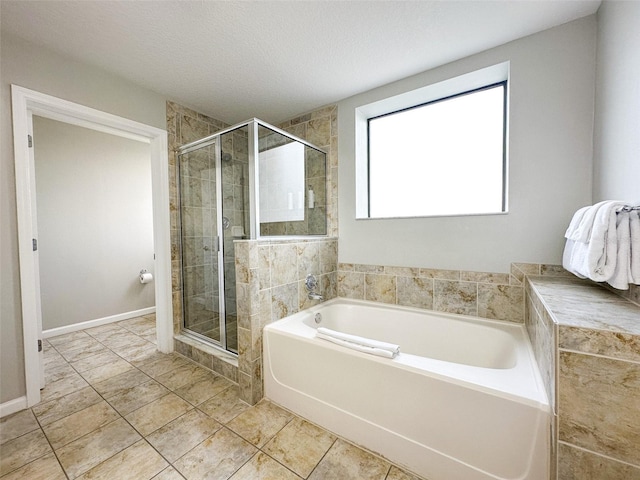 bathroom featuring separate shower and tub, a textured ceiling, and tile patterned floors