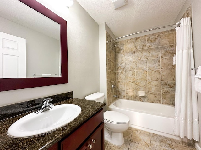 full bathroom featuring a textured ceiling, toilet, tile patterned floors, vanity, and shower / tub combo with curtain