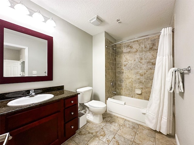 full bathroom featuring shower / bath combination with curtain, a textured ceiling, toilet, vanity, and tile patterned floors