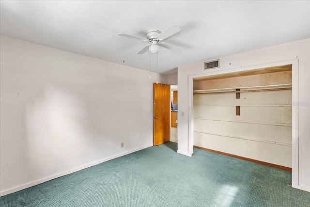 unfurnished bedroom with dark colored carpet, a closet, and ceiling fan