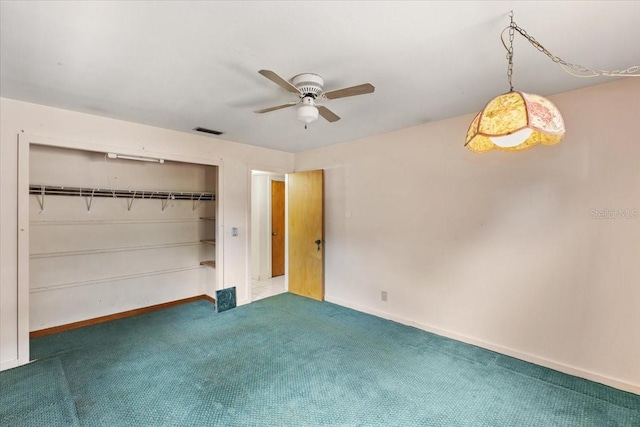 carpeted spare room with ceiling fan