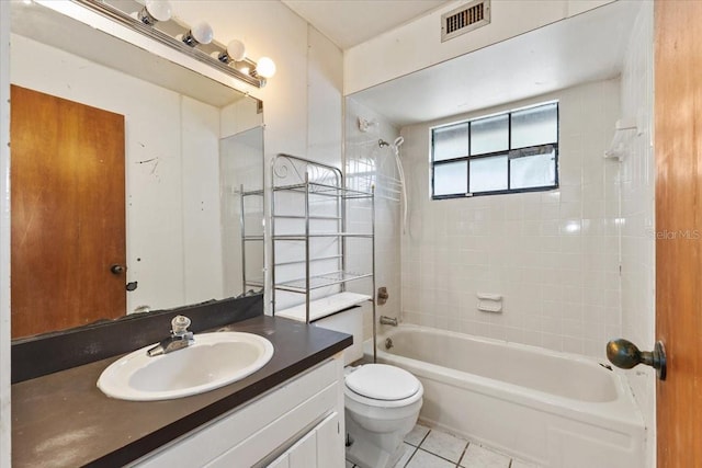 full bathroom with vanity, toilet, tile patterned floors, and tiled shower / bath