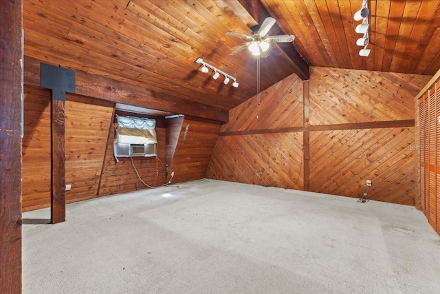 additional living space featuring lofted ceiling with beams, carpet flooring, wooden ceiling, and wood walls