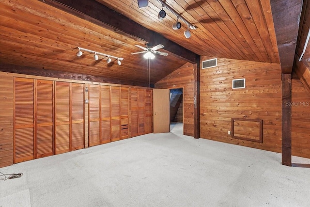 additional living space with carpet flooring, ceiling fan, wooden ceiling, vaulted ceiling, and wooden walls