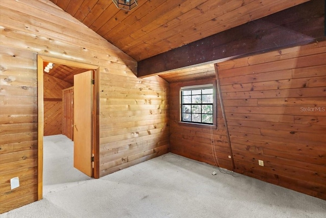 carpeted spare room with lofted ceiling, wooden ceiling, and wood walls