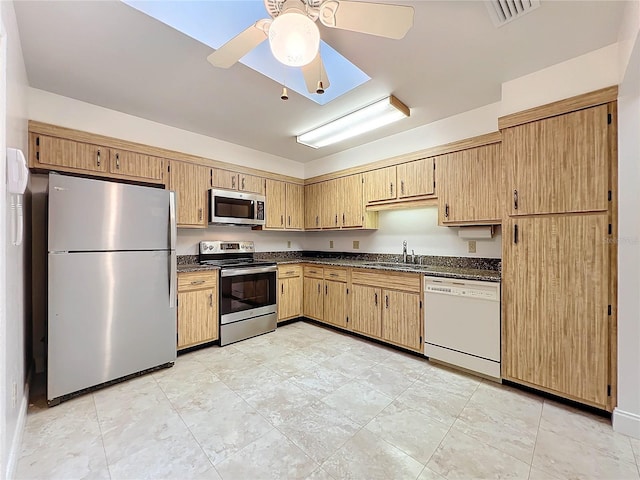 kitchen featuring light brown cabinets, stainless steel appliances, sink, and ceiling fan