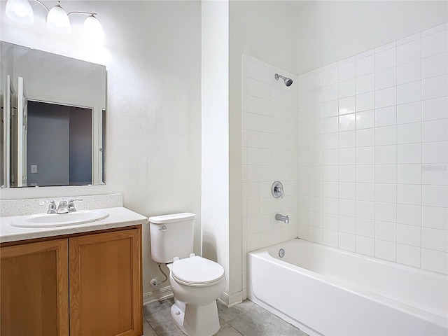 full bathroom featuring vanity, toilet, tiled shower / bath combo, and tile patterned flooring