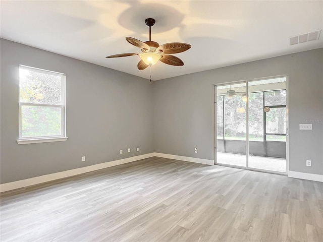 empty room featuring light hardwood / wood-style flooring and ceiling fan