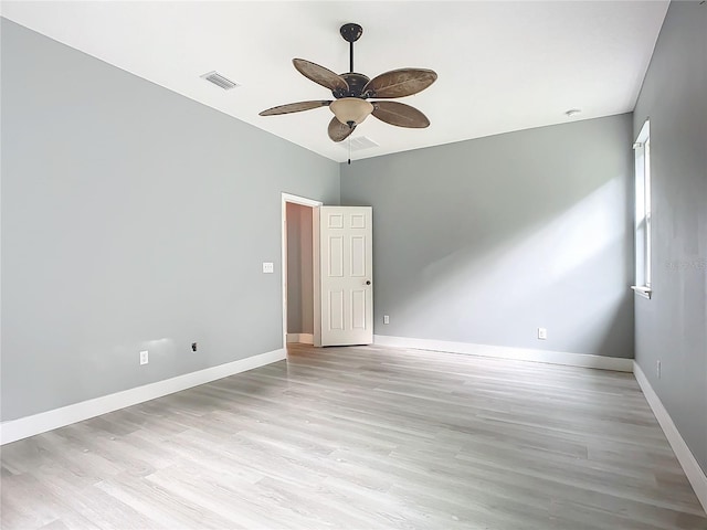 spare room featuring light hardwood / wood-style flooring and ceiling fan