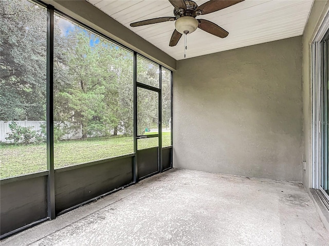 unfurnished sunroom with ceiling fan