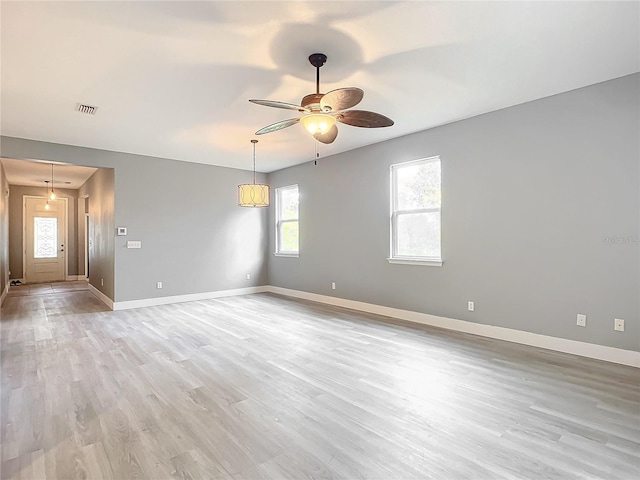 spare room featuring light wood-type flooring and ceiling fan