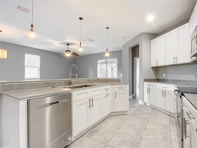 kitchen featuring sink, white cabinets, stainless steel appliances, and a healthy amount of sunlight