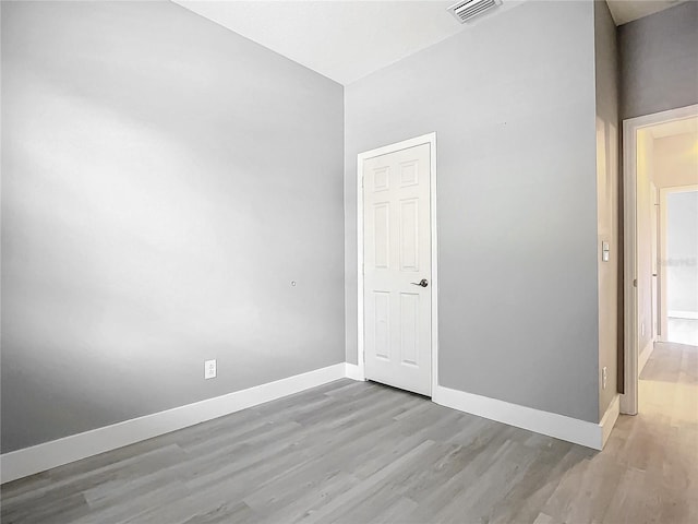 empty room with light hardwood / wood-style floors