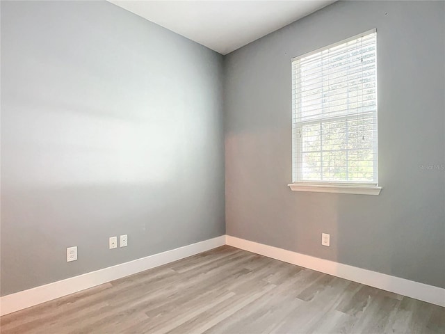 unfurnished room with light wood-type flooring