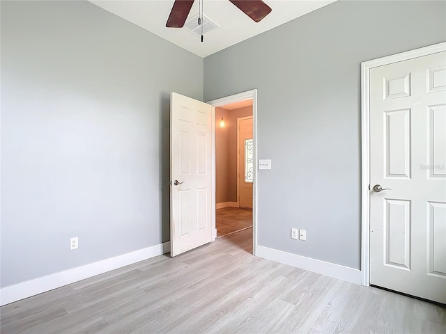 unfurnished bedroom with ceiling fan and light wood-type flooring