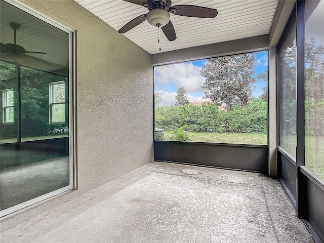 unfurnished sunroom featuring wooden ceiling and ceiling fan