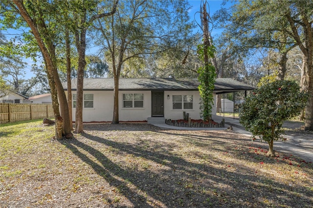 view of front of house with a front yard and a carport