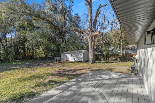 wooden deck featuring a yard and a shed