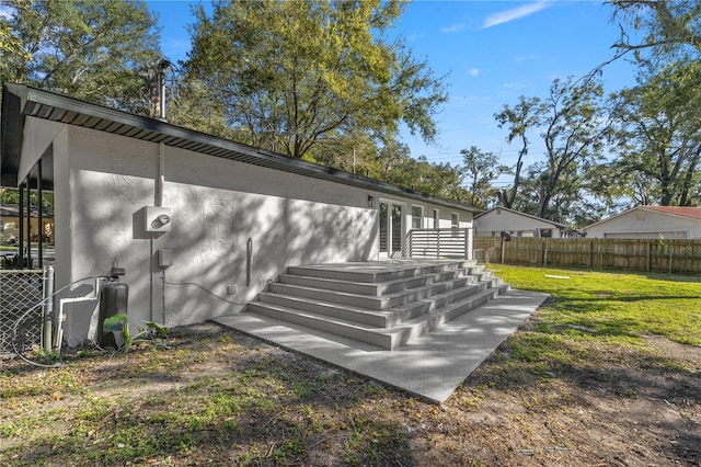 view of side of home with a lawn and a deck