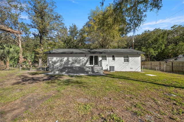 back of property featuring a yard and cooling unit