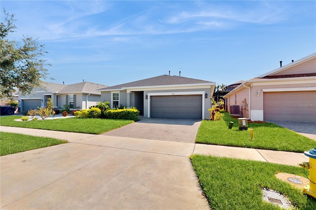 ranch-style house with central air condition unit, a front lawn, and a garage