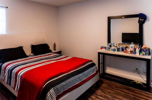 bedroom featuring dark hardwood / wood-style flooring